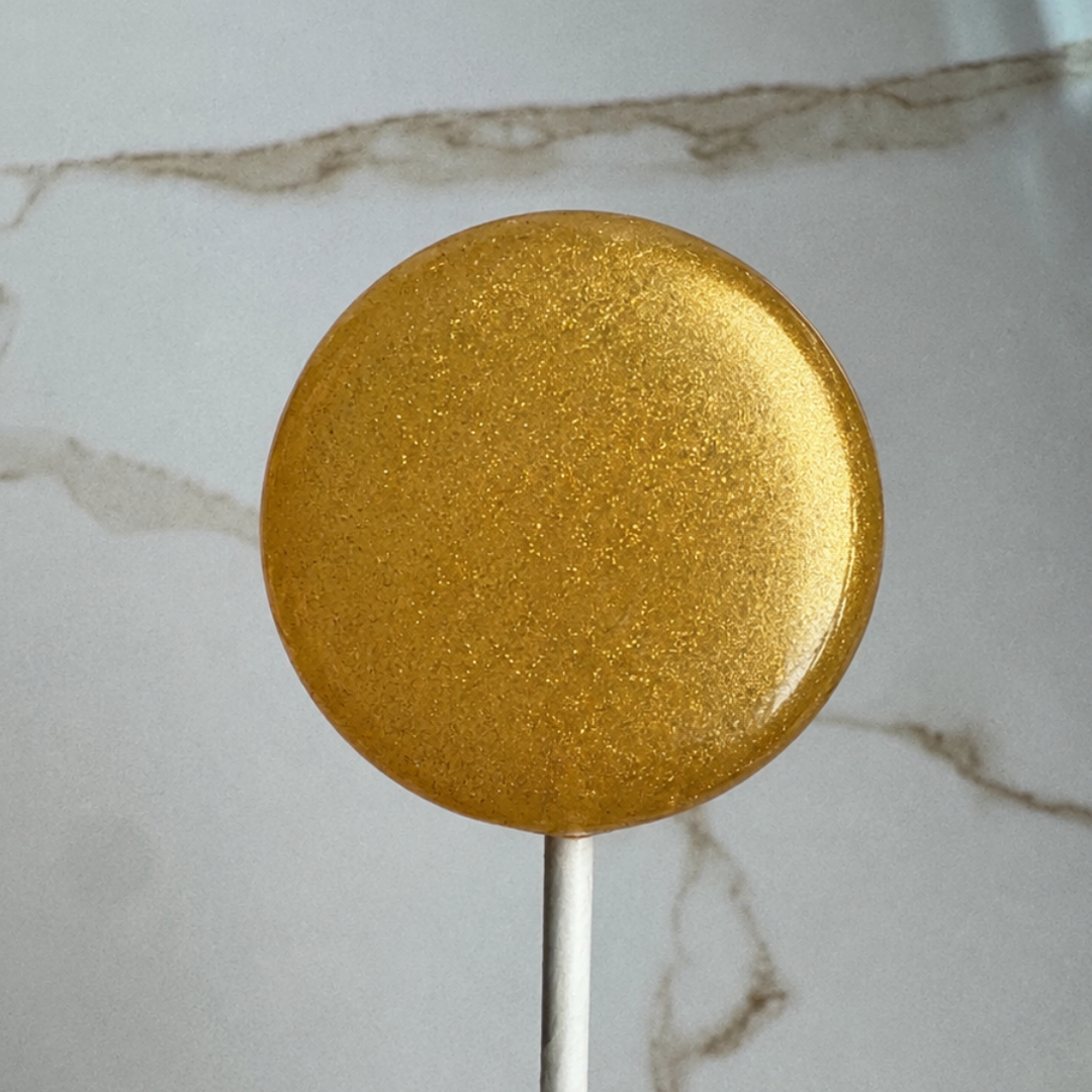 Quinceañera lollipop favor in pink and gold, handcrafted by Luna Candy Co.