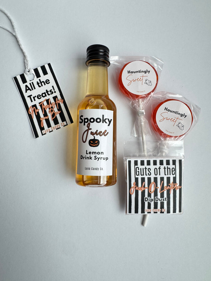 A Halloween-themed treat bundle on a light gray background, featuring a miniature bottle of &