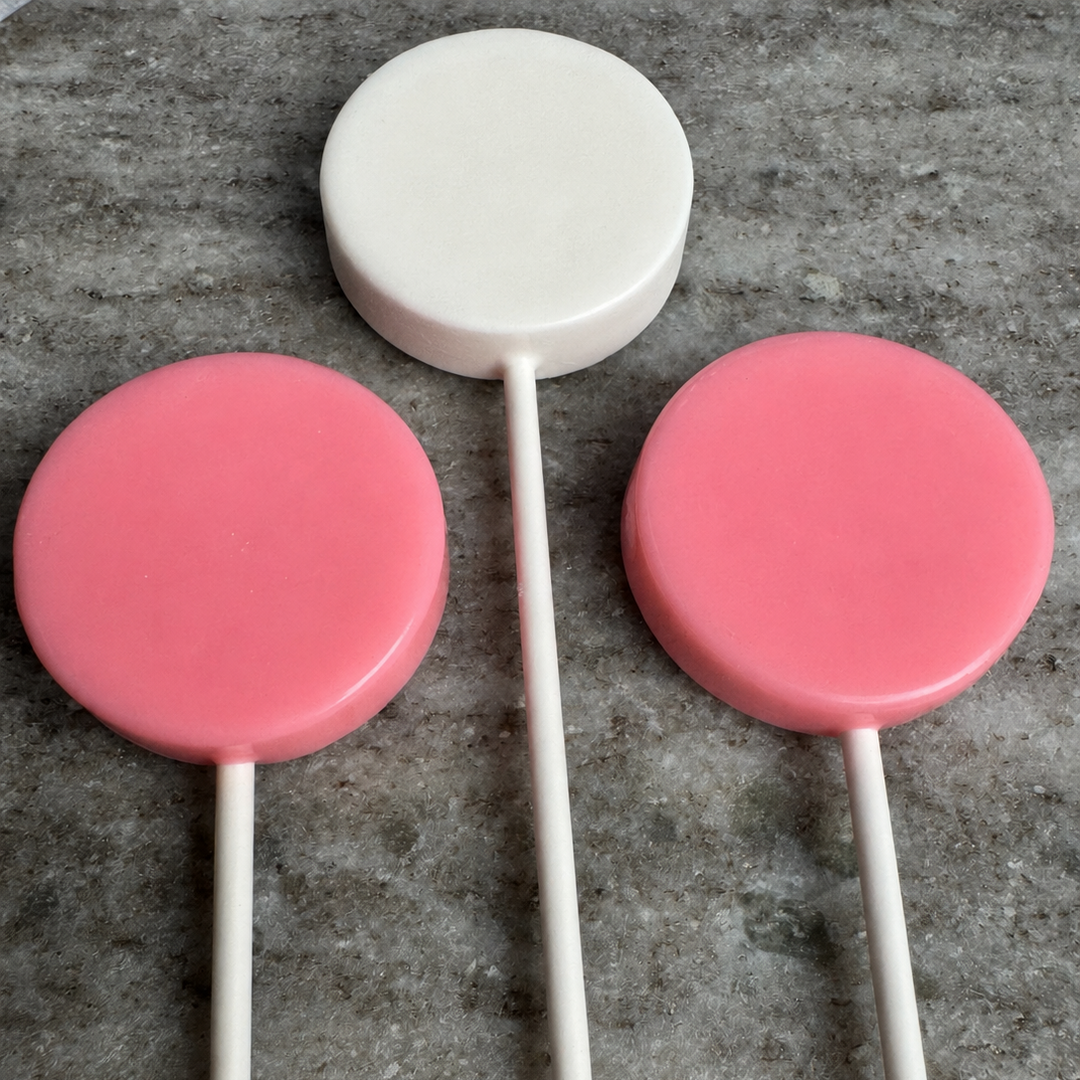 It's a Girl baby shower lollipops in soft pink and white, handcrafted by Luna Candy Co.