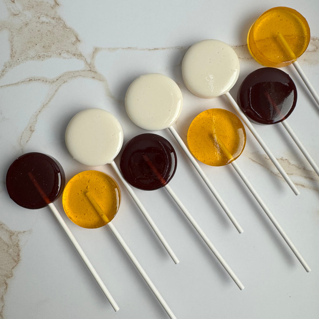 Honey Bee baby shower lollipops in yellow, brown, and white, handcrafted by Luna Candy Co.