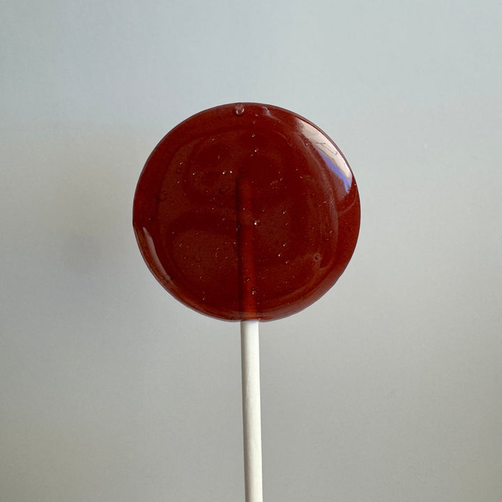 Honey Bee baby shower lollipop favors styled for a gender-neutral baby shower