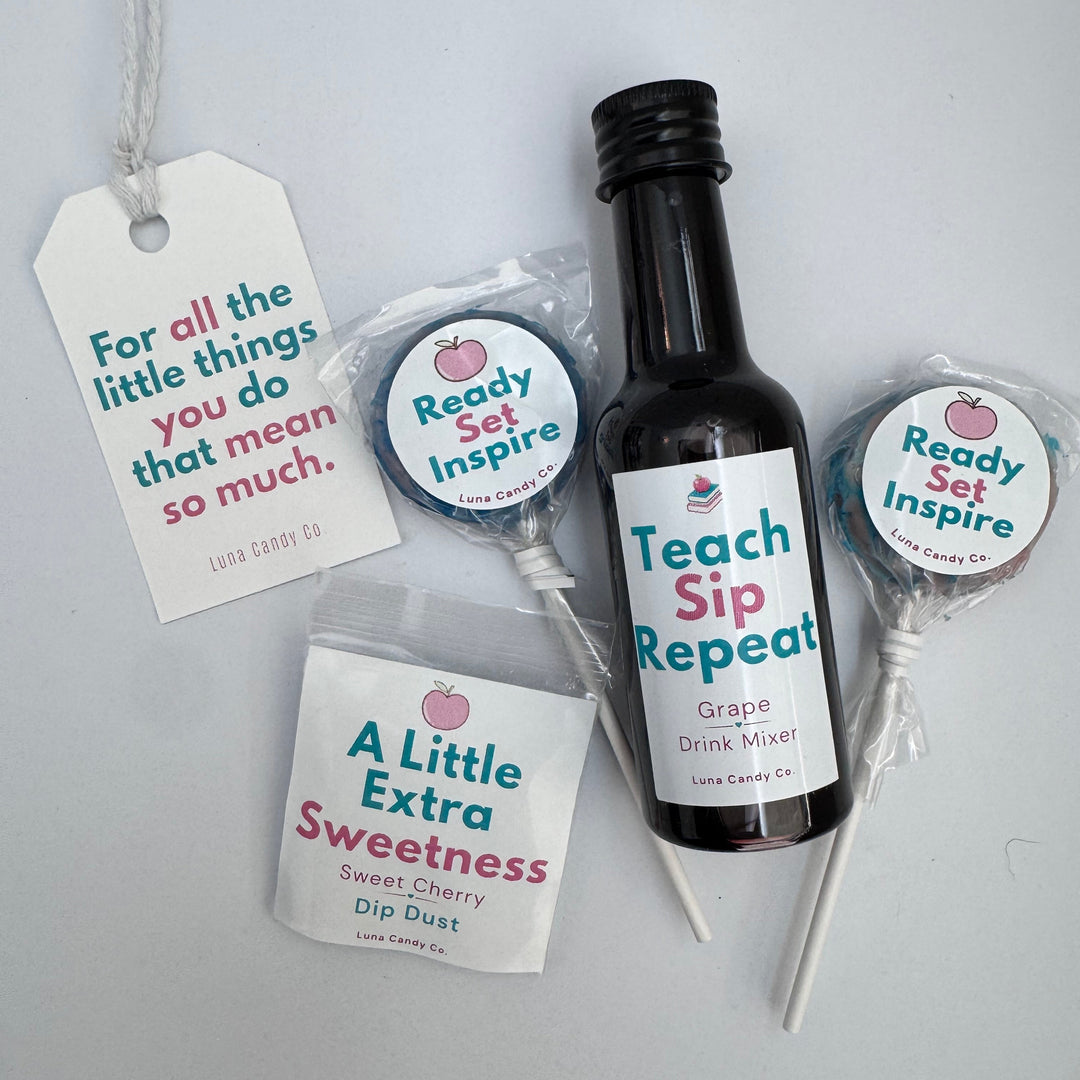 A gift set of personalized drink accessories including a black bottle labeled with grape drink syrup &