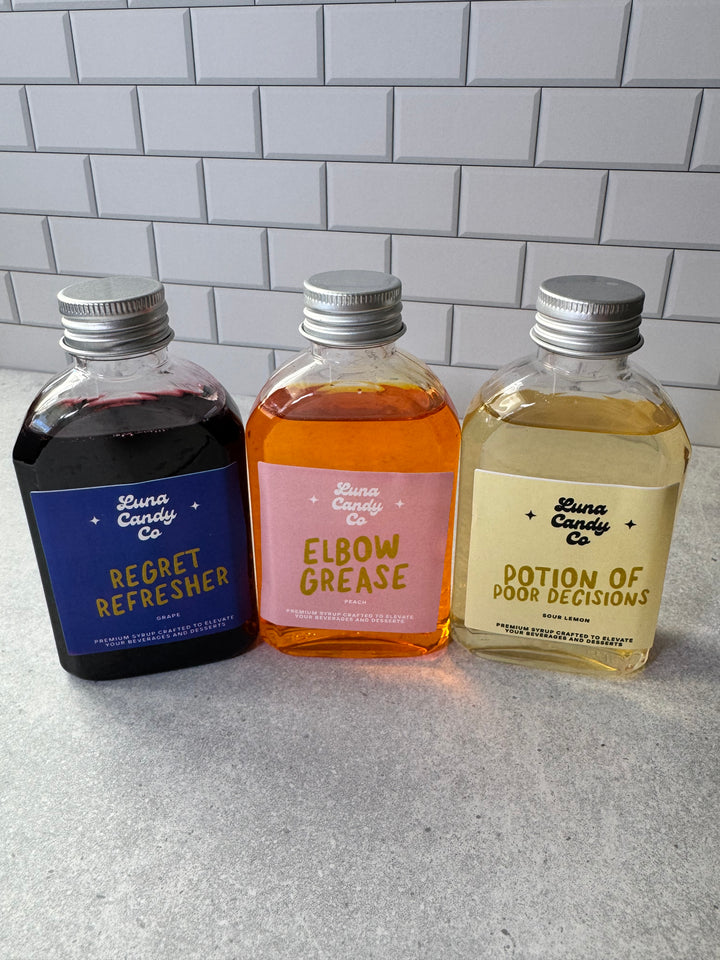 Three small drink mix bottles labeled &