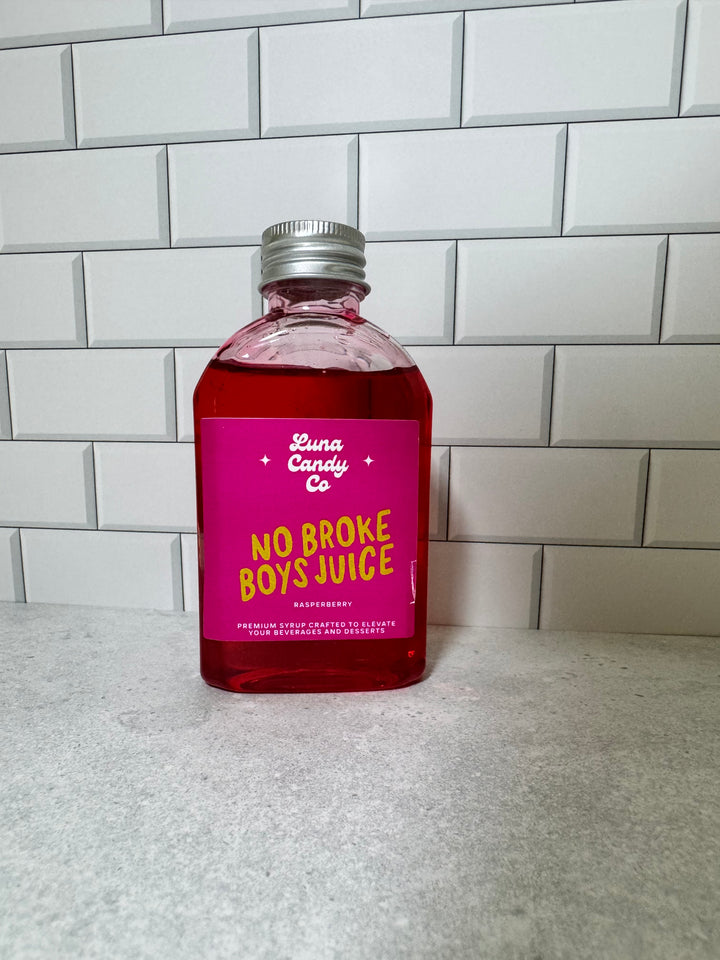 Luna Candy Co No Broke Boys Juice Raspberry Drink Syrup against white subway tile