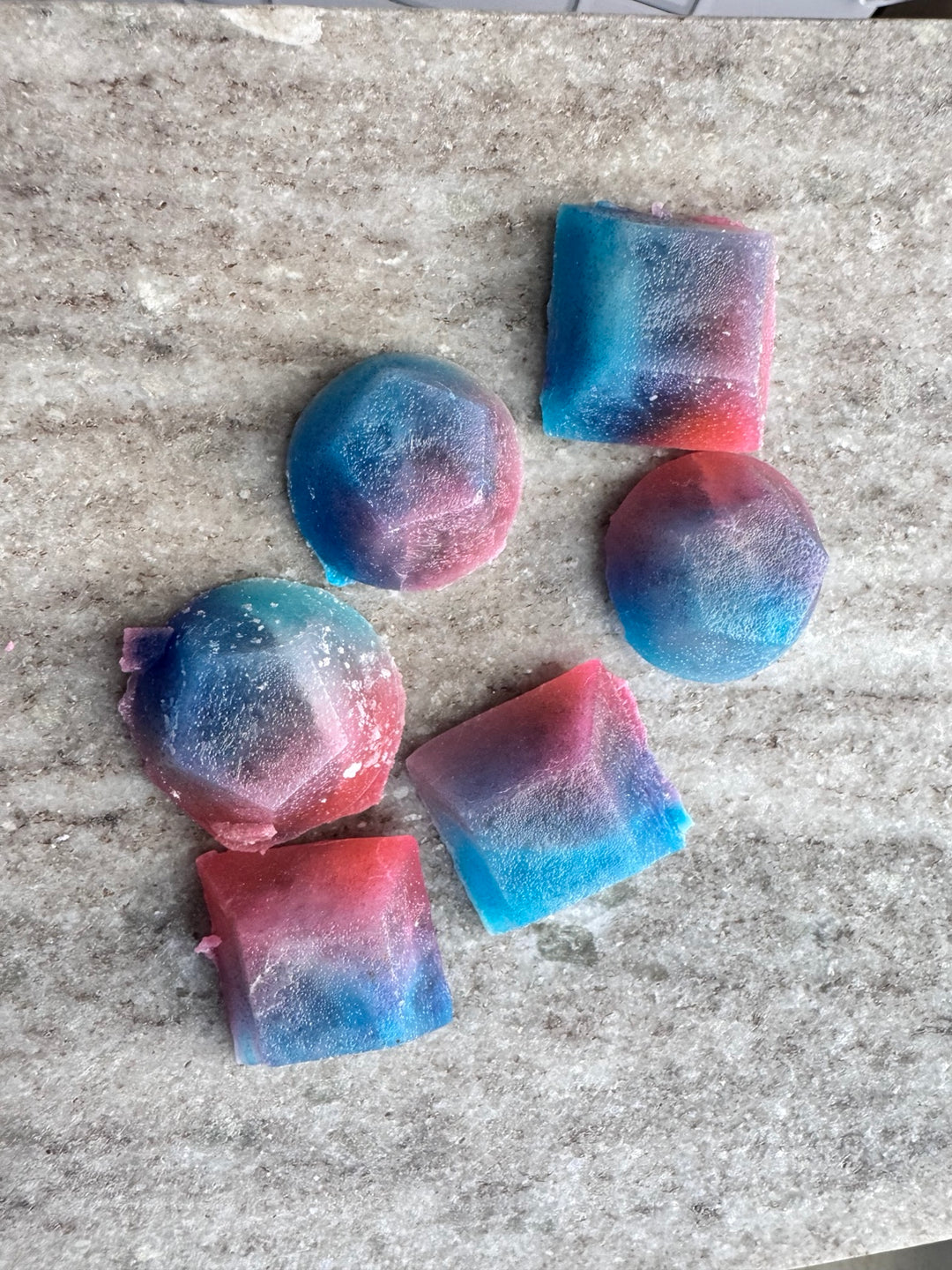 Close-up assortment of molded blue, purple, and pink kohakutou candies