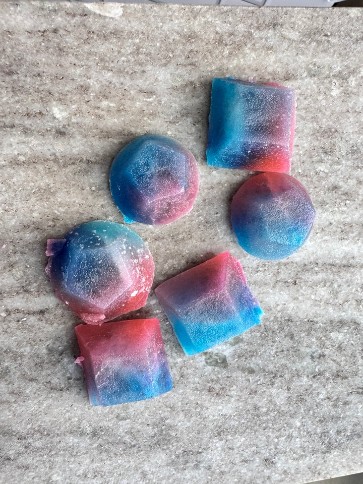 Close-up assortment of molded blue, purple, and pink kohakutou candies