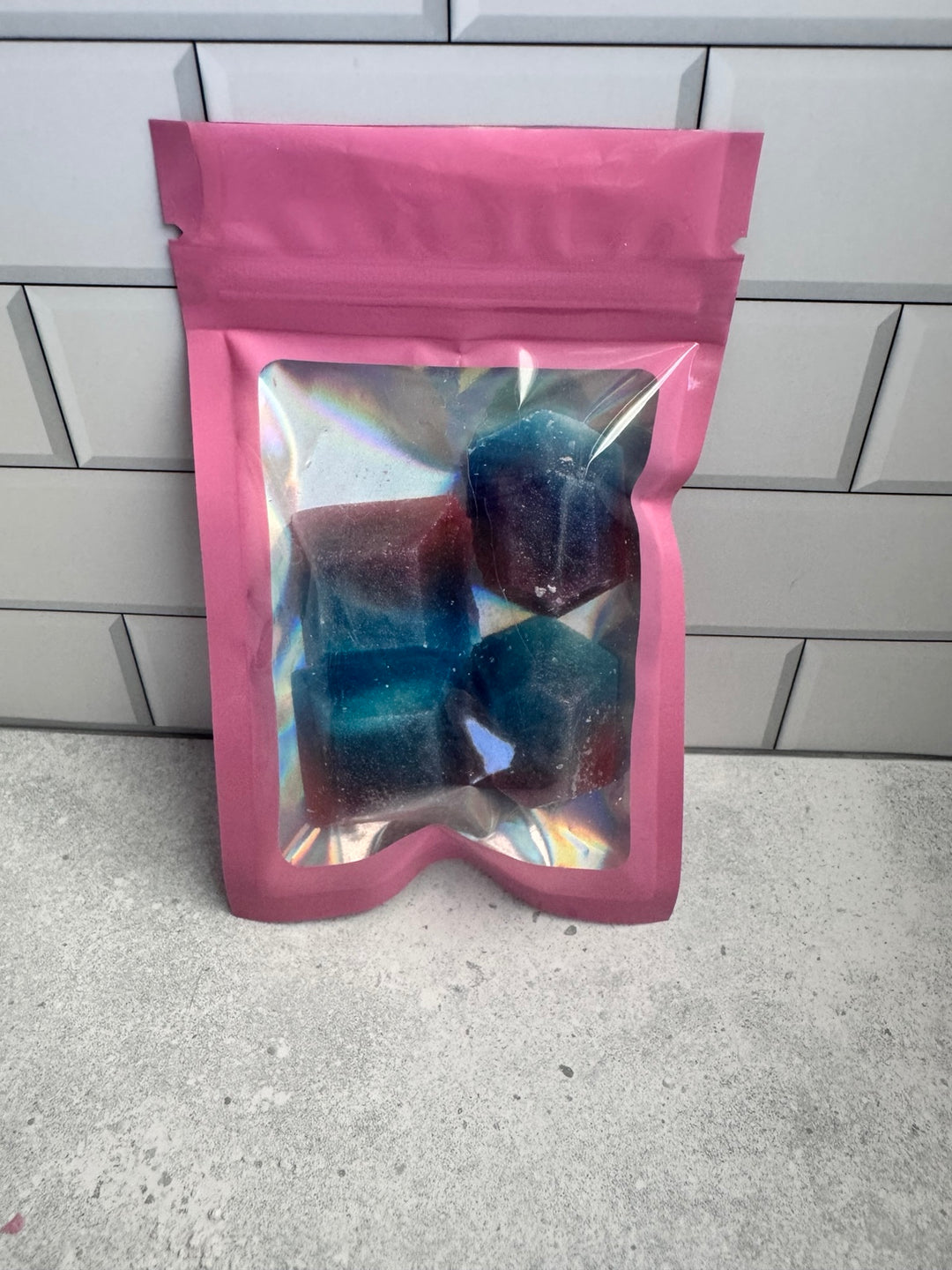 Four cotton candy and strawberry kohakutou candies packaged in a pink holographic pouch